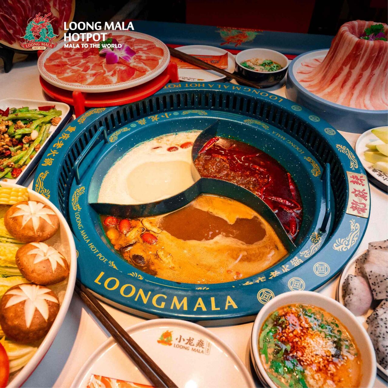 An authentic Chongqing-style triple-flavor hot pot featuring spicy Mala, herbal Pork Bone, and Mushroom broths at LoongMala (LoongMala), Donki Mall (Donki Mall) Thong Lor.