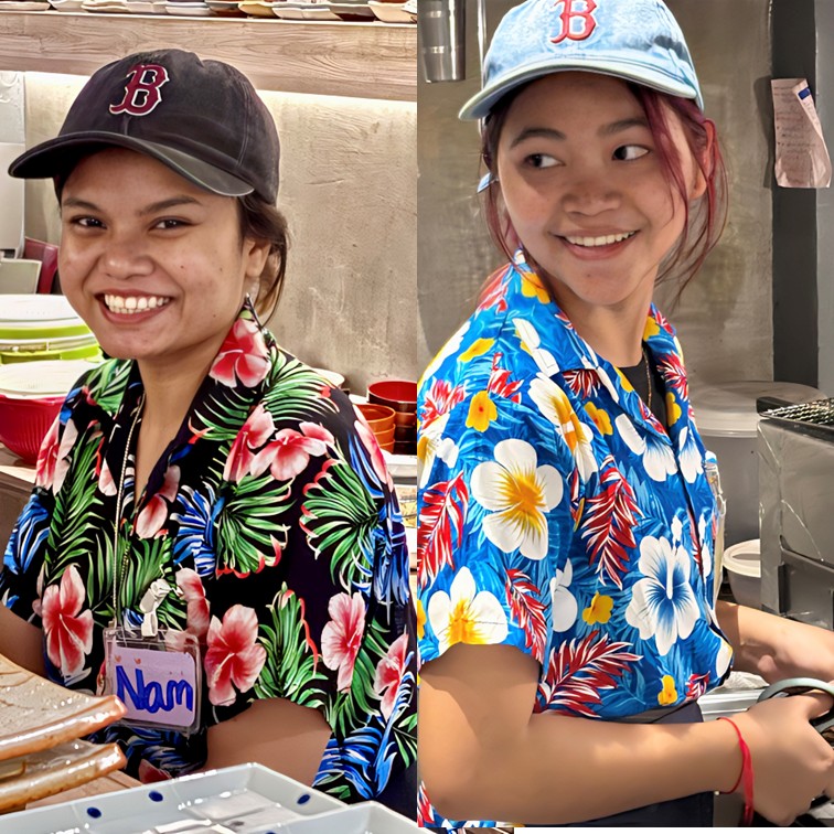 A friendly and professional staff member smiling and providing excellent service to guests at Okinawa Shubo Kanemaru, a Japanese Okinawan Izakaya in Sukhumvit 71, Bangkok.